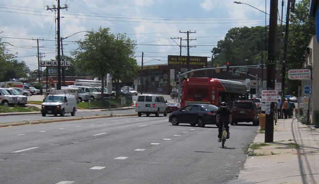 Looking West Along East-West Highway in the Ethan ALlen Gateway Streetscape Area. Excess roadway devoted to cars does not accommodate pedestrians, bicyclists, and transit users.