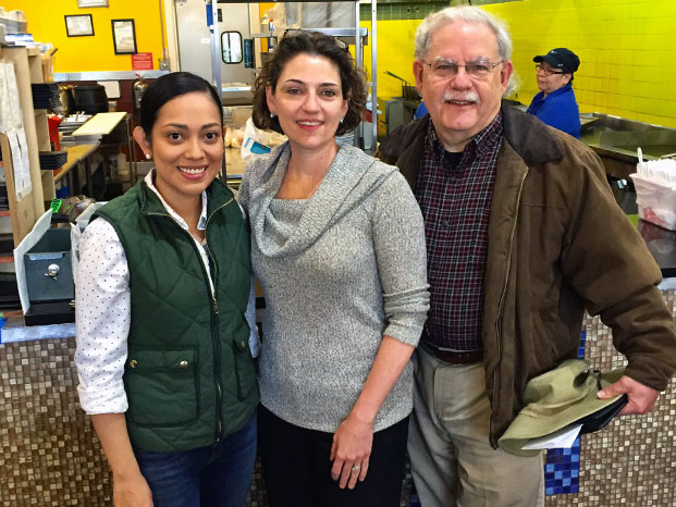 Photo of (from left to right) of the owner of Pupuseria El Comalito with Mayor Kate Stewart and Ward 6 Councilmember Fred Schultz